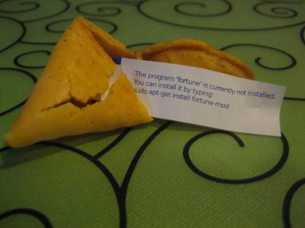 Photo of a fortune cookie cracked open with the paper sticking out. The fortune says: "The program 'fortune' is currently not installed. You can install it by typing: sudo apt-get install fortune-mod."