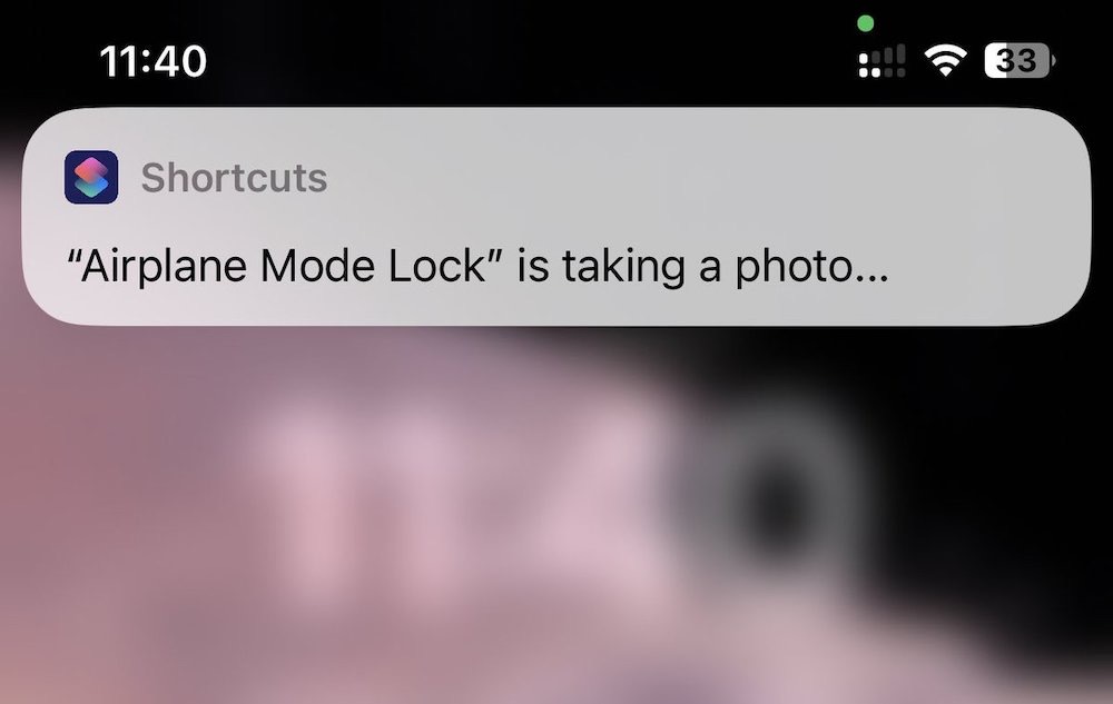 A screenshot of an iOS shortcut running that says, "Airplane Mode Lock is taking a photo..."