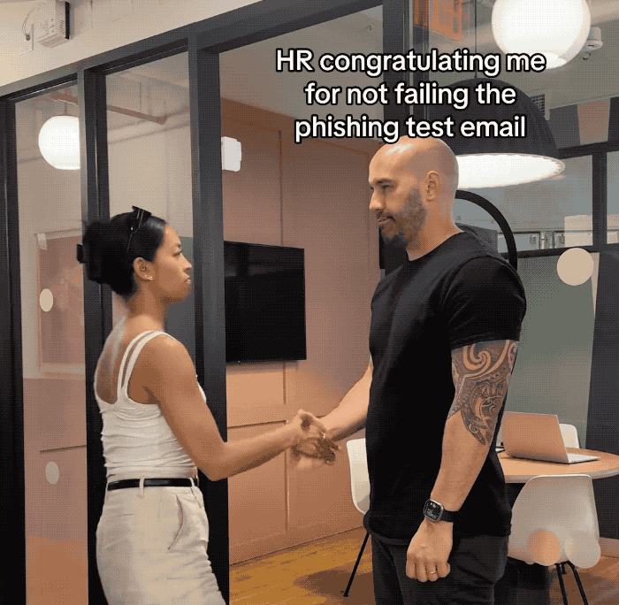 An animated GIF of two people shaking hands, one says "HR congratulating me for not failing the phishing test email," and the other person saying "me who doesn't read emails"