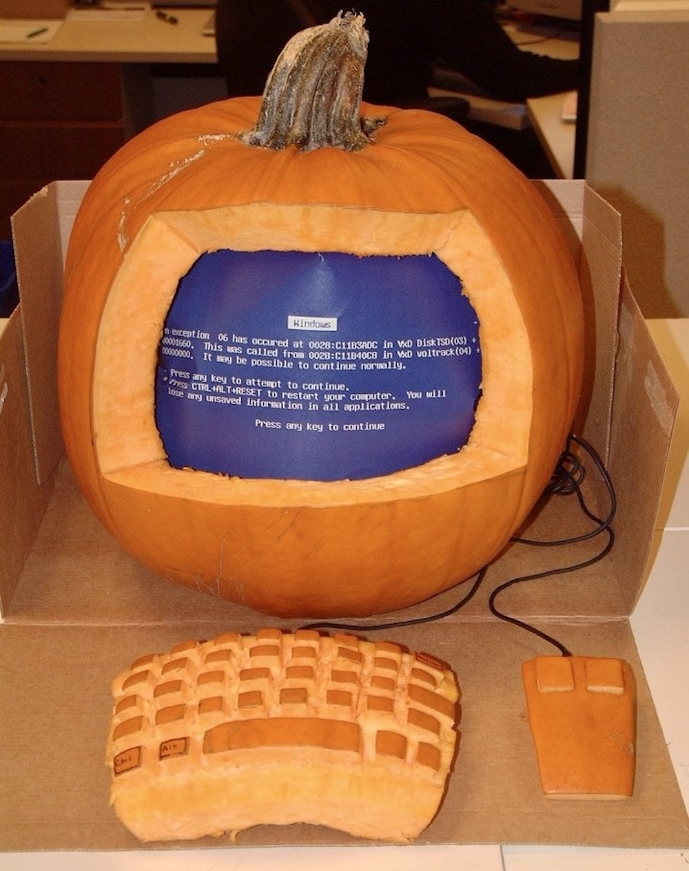 A pumpkin with a Windows blue-screen-of-death inside the pumpkin.