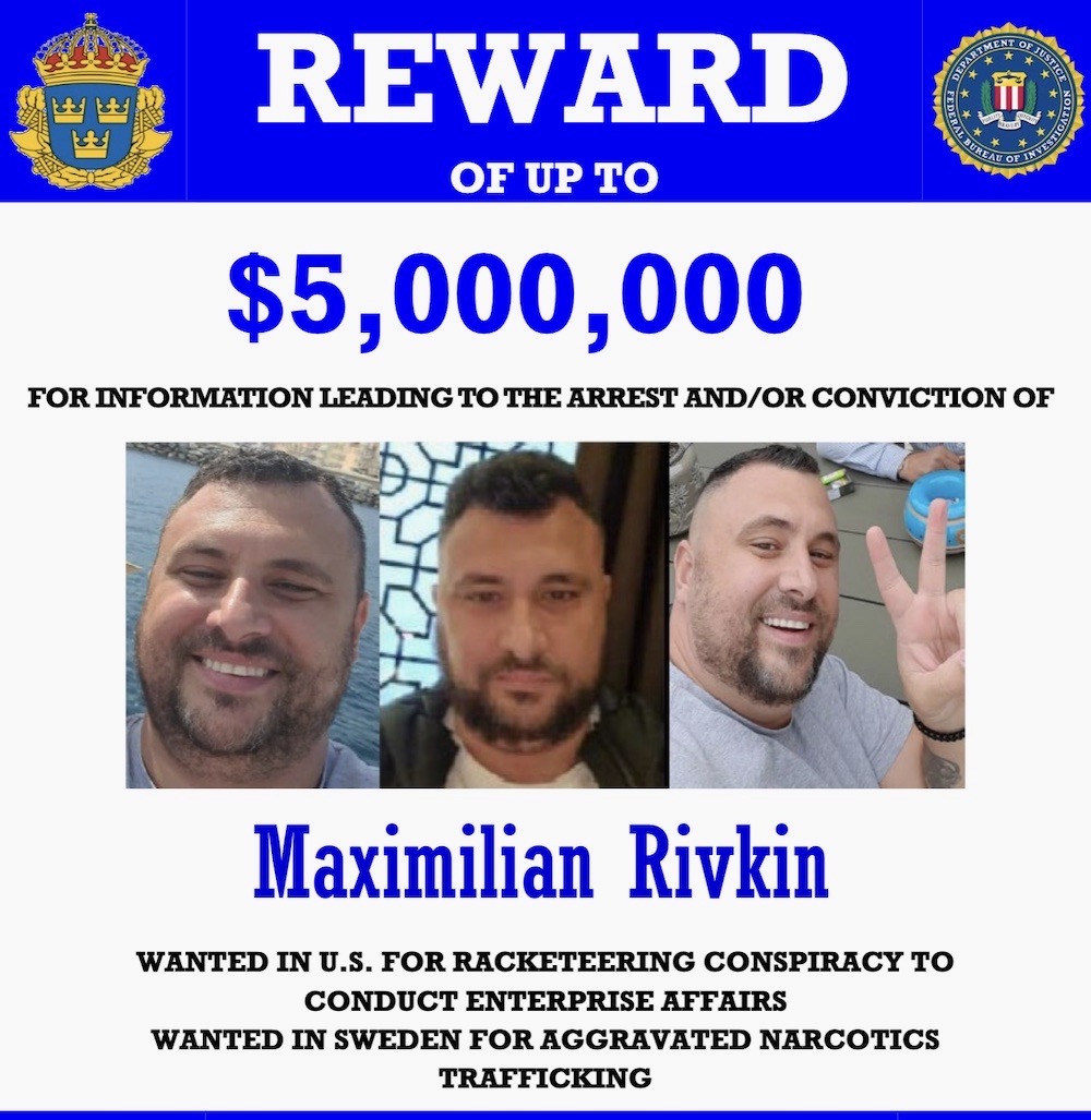 A reward/wanted poster for Maximilian Rivkin published by the State Dept. Rivkin can be seen smiling and holding up the peace sign in the published photos.