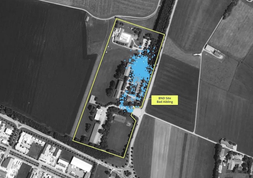 An aerial monochrome image of a BND site in Germany, with blue location dots all over its buildings.