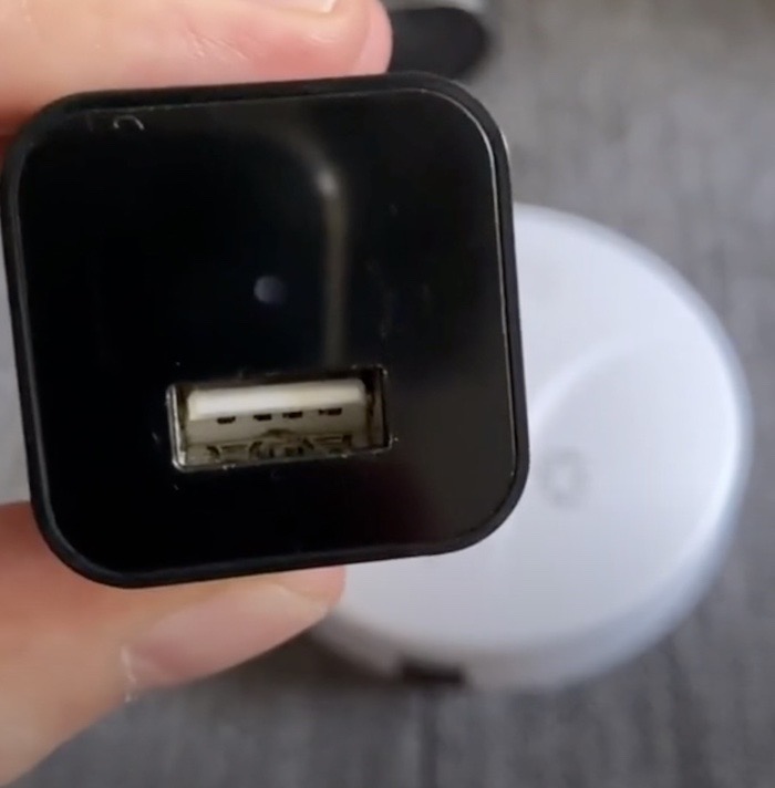 A photo of a USB wall charger with a hidden camera inside.