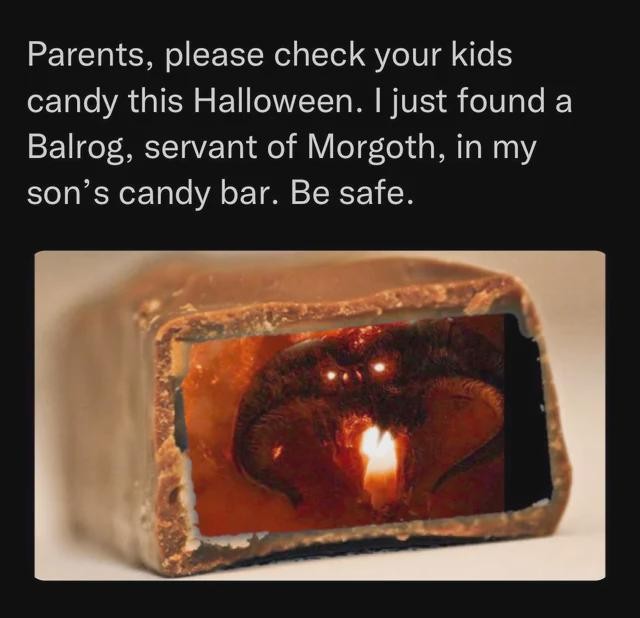 A cut-through photo of a candy bar with a photo of Balrog inside, with the caption: "Parents, please check your kids candy this Halloween. I just found a Balrog, servant of Morgoth, in my son's candy bar. Be safe."