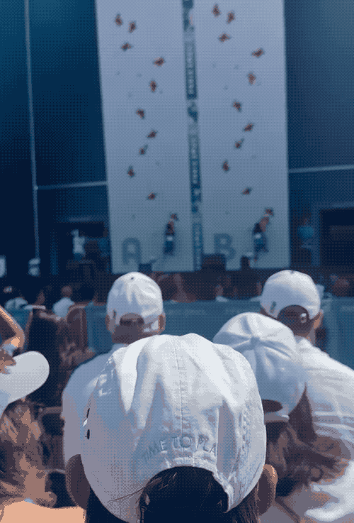 An animated GIF showing Sam Watson (left) climbing up a 15 meter wall in about 5 seconds, while the other climber on the right falls far behind.