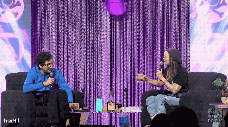 Jeff Moss (left) and Jen Easterly (right) on stage at Def Con clinking a cocktail glass each 