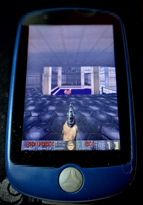 A photo showing a bicyle navigator device that's running Doom.