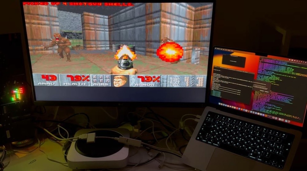 A photo of Doom running on a computer monitor connected to a Mac; the chip on the dongle is running the game.