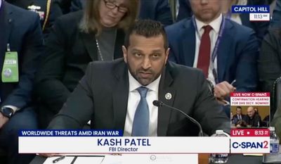 a screenshot of a C-SPAN stream showing FBI director Kash Patel testifying to lawmakers on Capitol Hill, with people sat behind him.