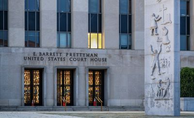 a photo outside the front doors of the E. Barrett Prettyman United States Court House in Washington, D.C., home to the United States District Court for the District of Columbia
