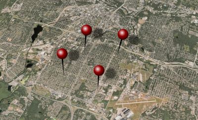 an aerial photo from Apple Maps of Akron, Ohio, with several illustrated clip-art pushpins in the map to refer to "stingray" cell-site simulator locations