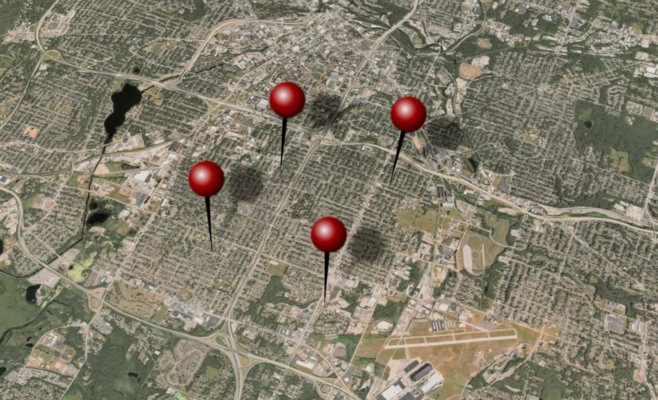 an aerial photo from Apple Maps of Akron, Ohio, with several illustrated clip-art pushpins in the map to refer to "stingray" cell-site simulator locations