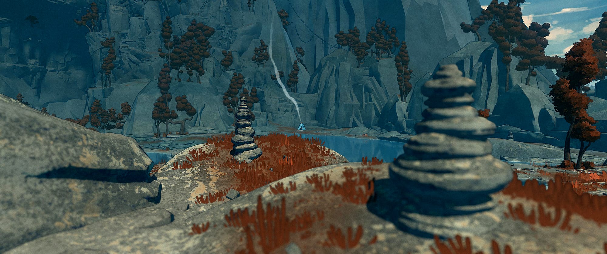 A view over a shallow lake, cairns stacked in the foreground and a blue tent emitting a plume of smoke at the far side.