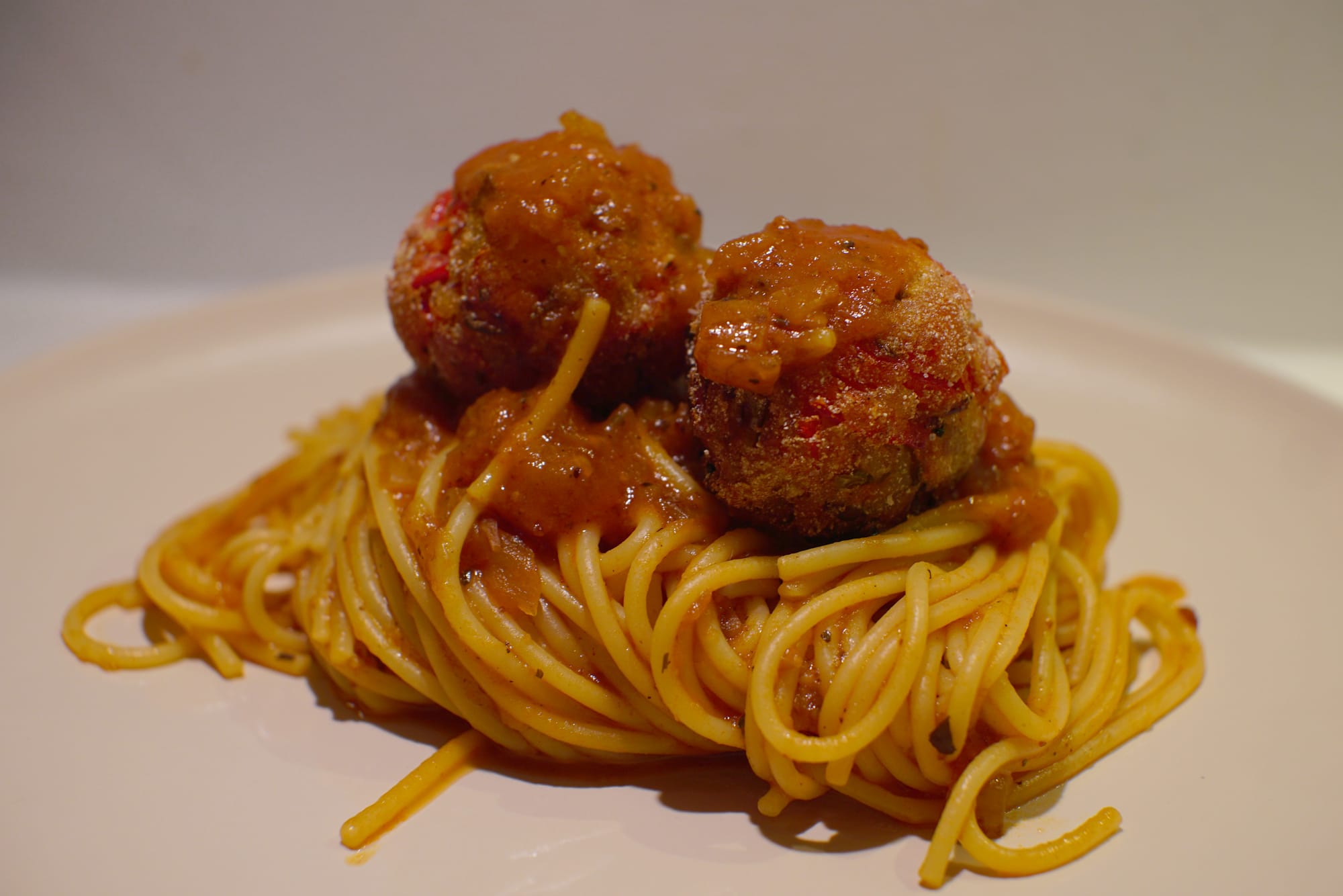 Spaghetti with default red sauce and vegetable balls.