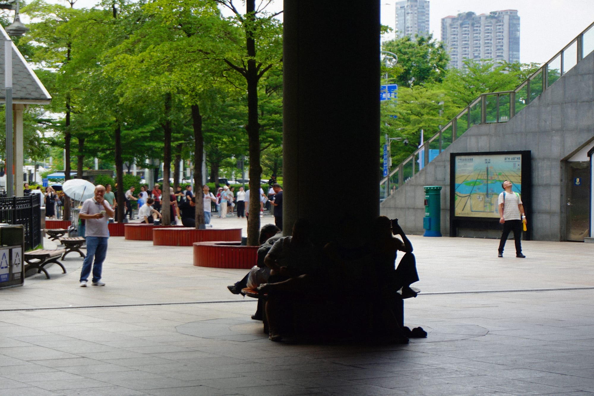 A crowd looks up at Canton Tower.