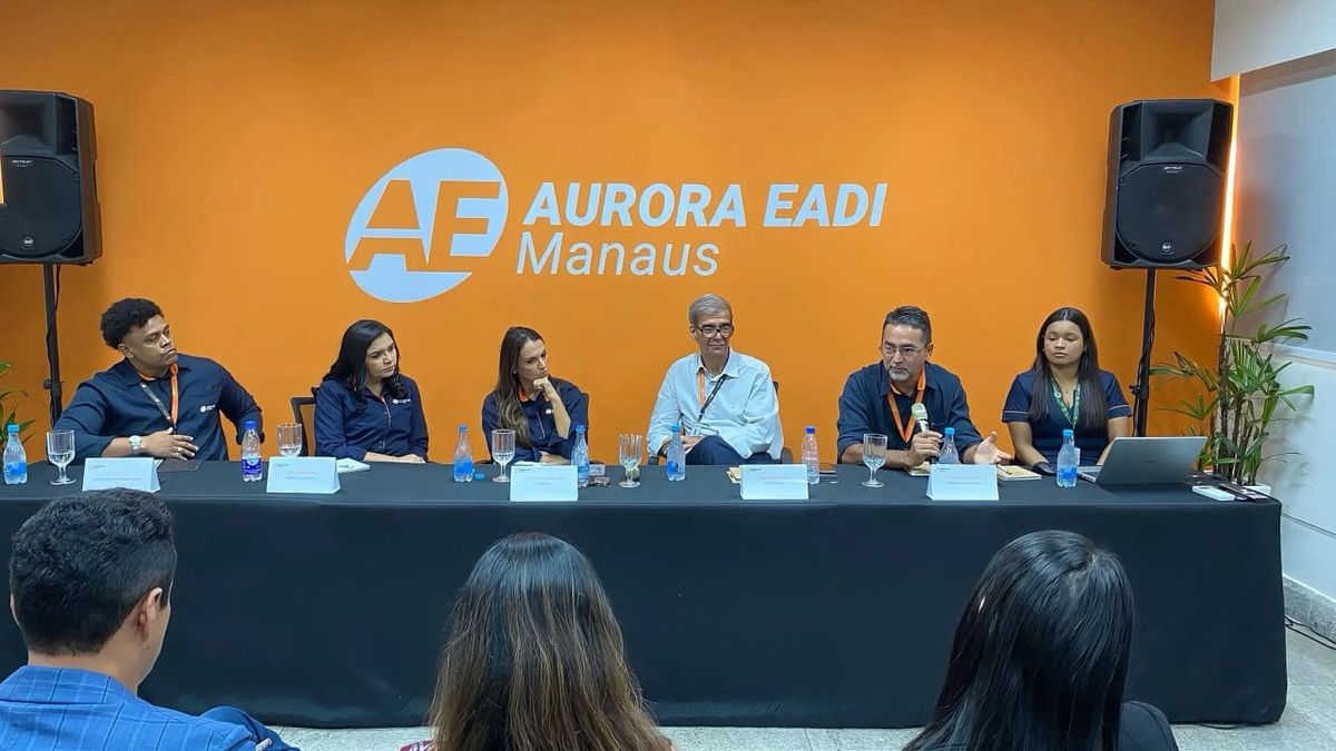 Membros da diretoria da Aurora EADI sentados em uma mesa, apresentando o sistema EIZOF e a nova gestão durante um café