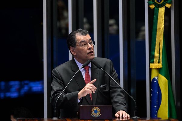 O senador Eduardo Braga discursa na tribuna do Senado Federal, vestindo terno escuro e gravata vermelha.