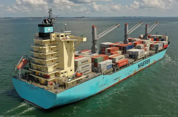 Navio cargueiro Maersk Kwangyang transportando contêineres coloridos em mar aberto sob céu com nuvens.
