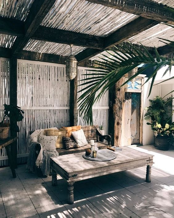 A shaded pergola lounge with palm shadows