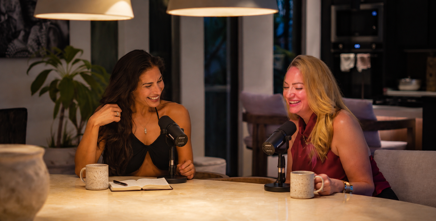 Savannah Rahman and Christa Shepherd in conversation at a table with microphones.