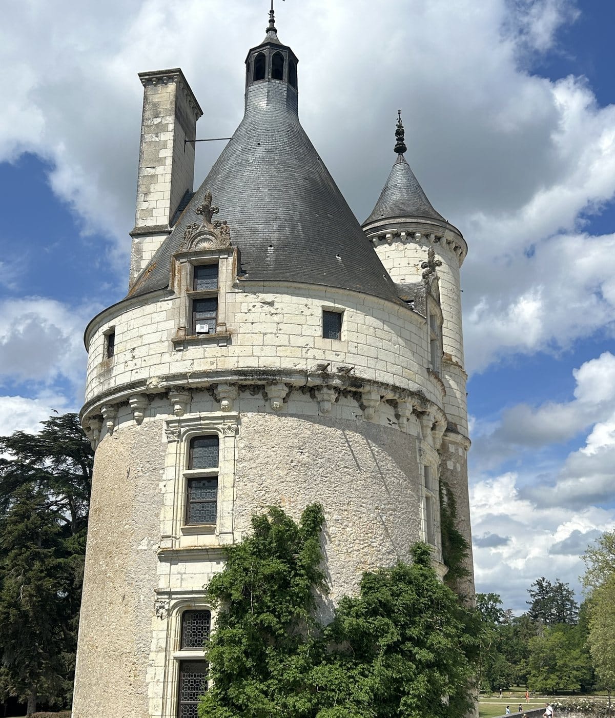The round tower of Chenonceau with a slate roof and carved stone details