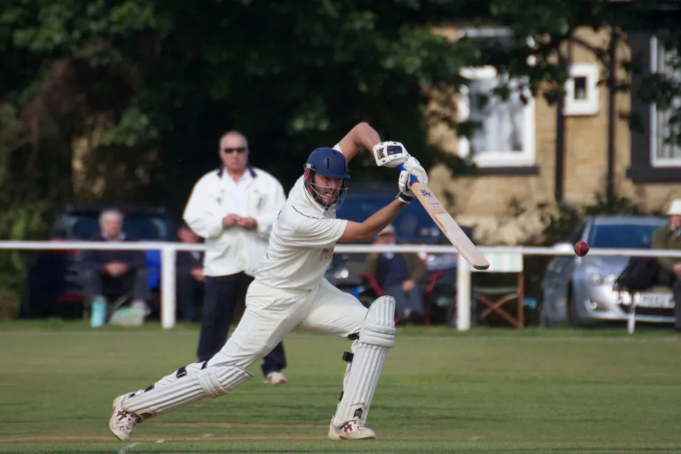 cricketer drives the ball