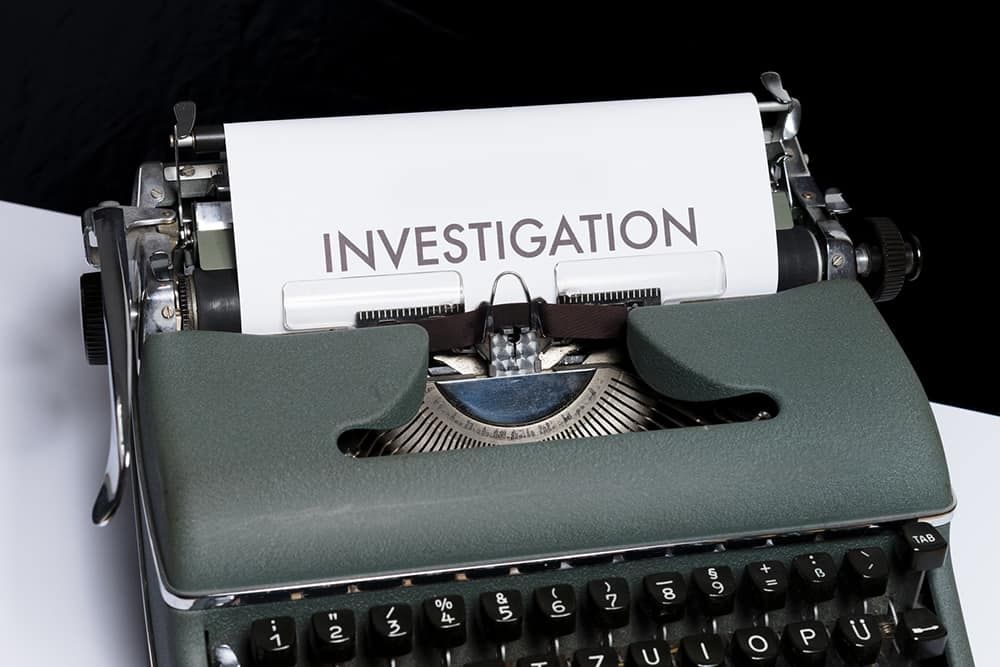 Typewriter showing page with text: investigation
