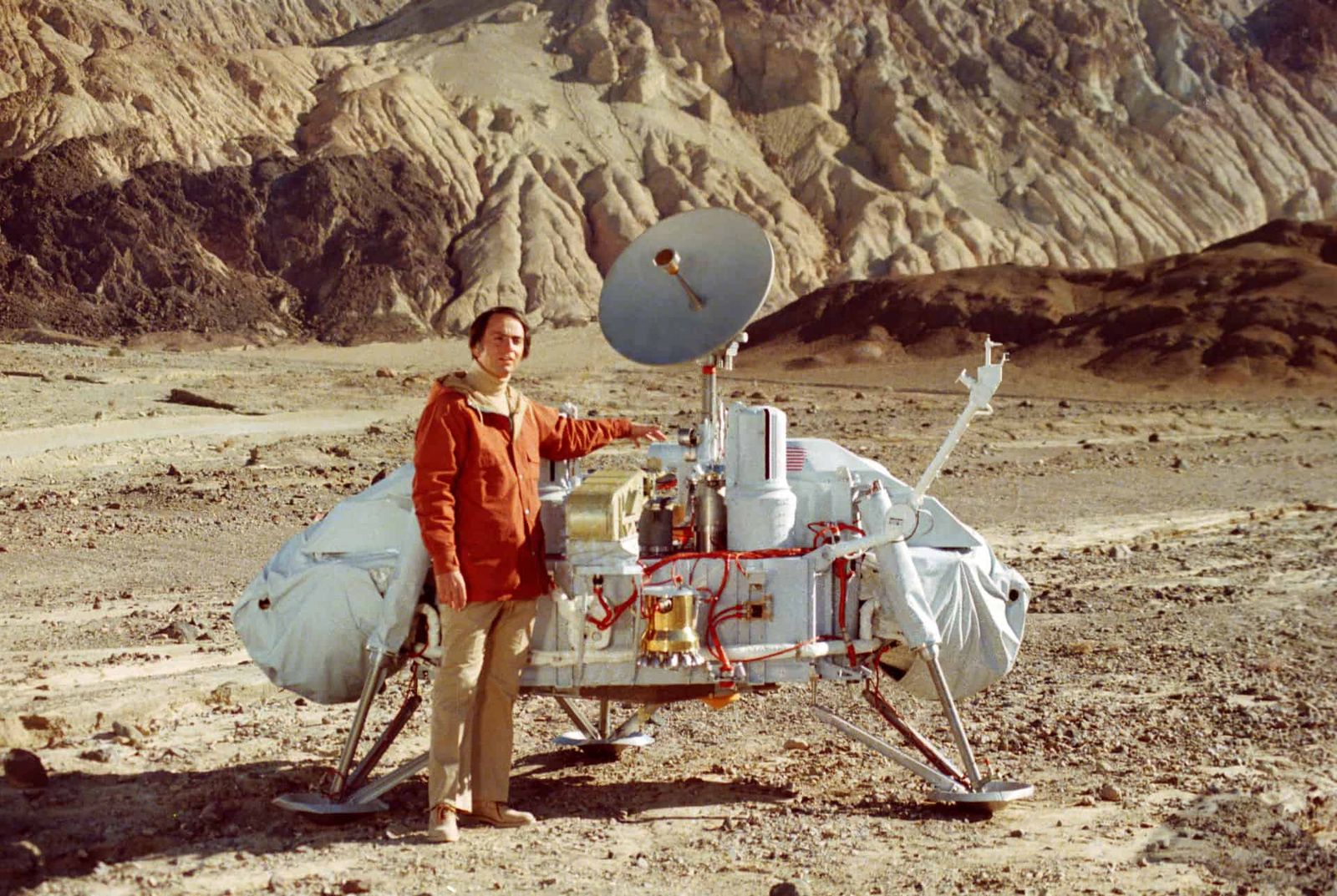 Dr. Carl Sagan poses with a model of the Viking lander