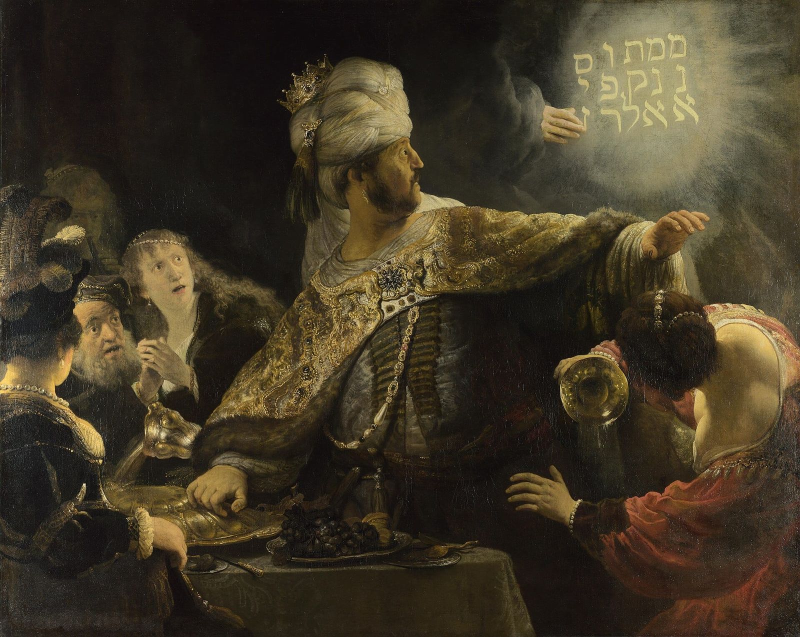 A richly dressed king recoils from a glowing hand writing on the wall behind him; figures around a banquet table react in alarm, one spilling wine from a golden vessel.