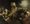 A richly dressed king recoils from a glowing hand writing on the wall behind him; figures around a banquet table react in alarm, one spilling wine from a golden vessel.
