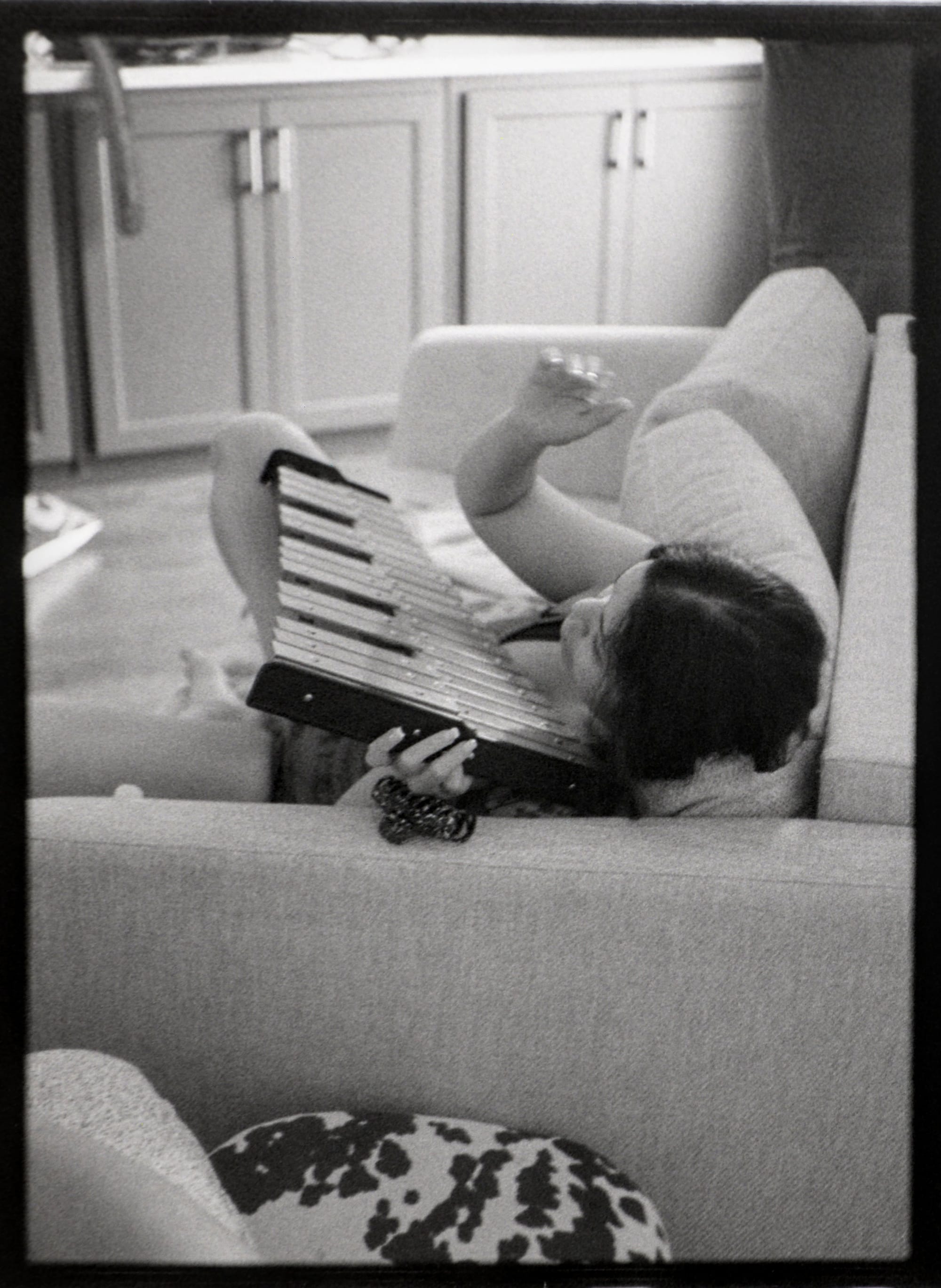 Mickey from Mia Antifa lays on our couch with a glockenspiel.