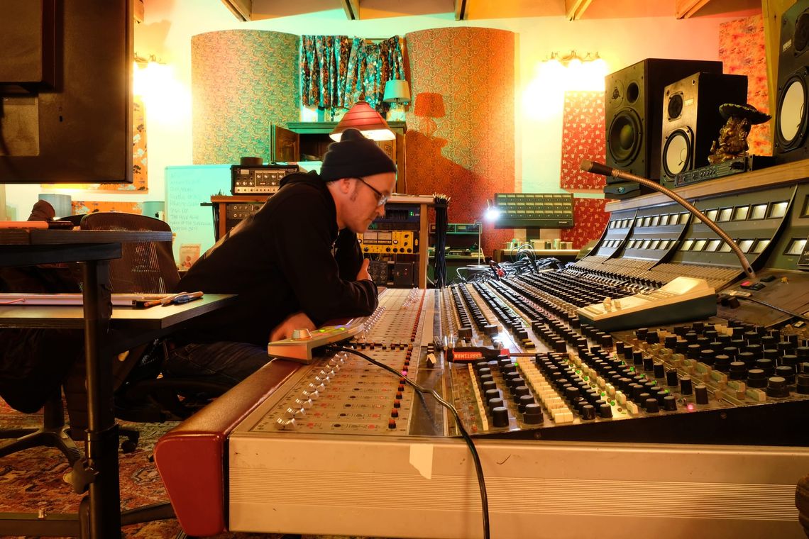 Self timer self portrait of Ross behind the Neve 8088 at Sonic Ranch's Adobe Studio.  He looks very focused.