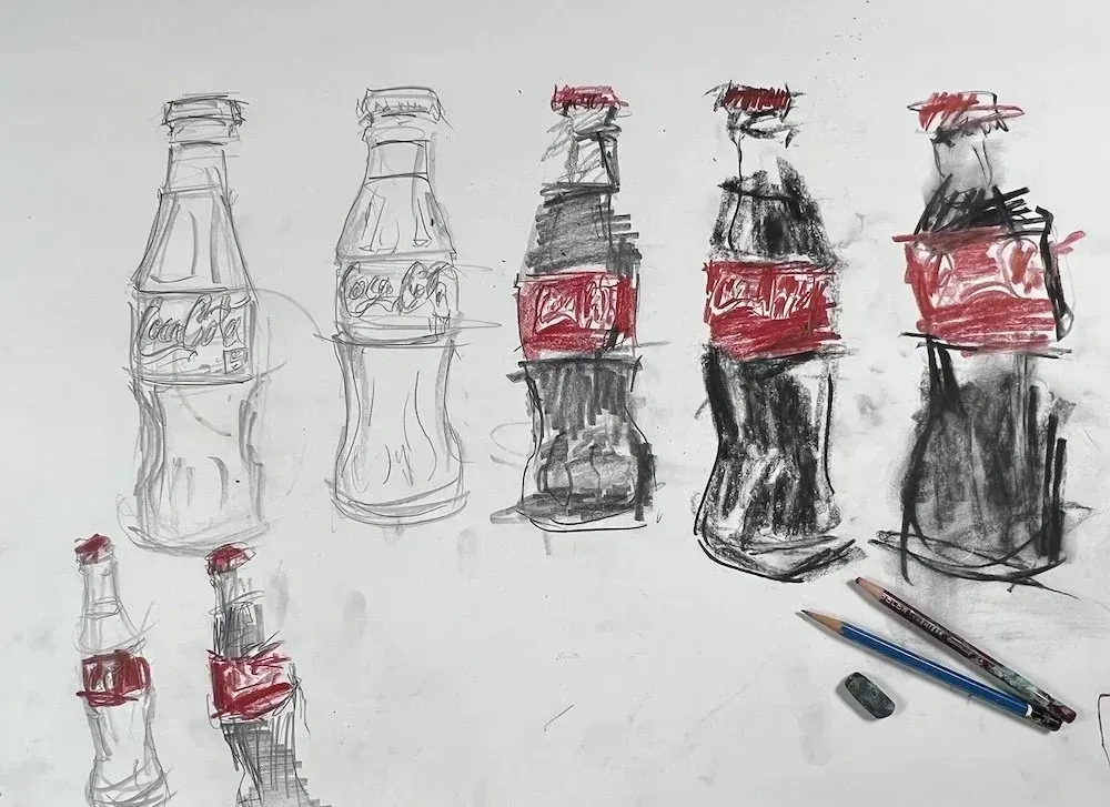 Coca-Cola bottle drawing progressions moving from light graphite studies to expressive charcoal and red colored pencil interpretations.
