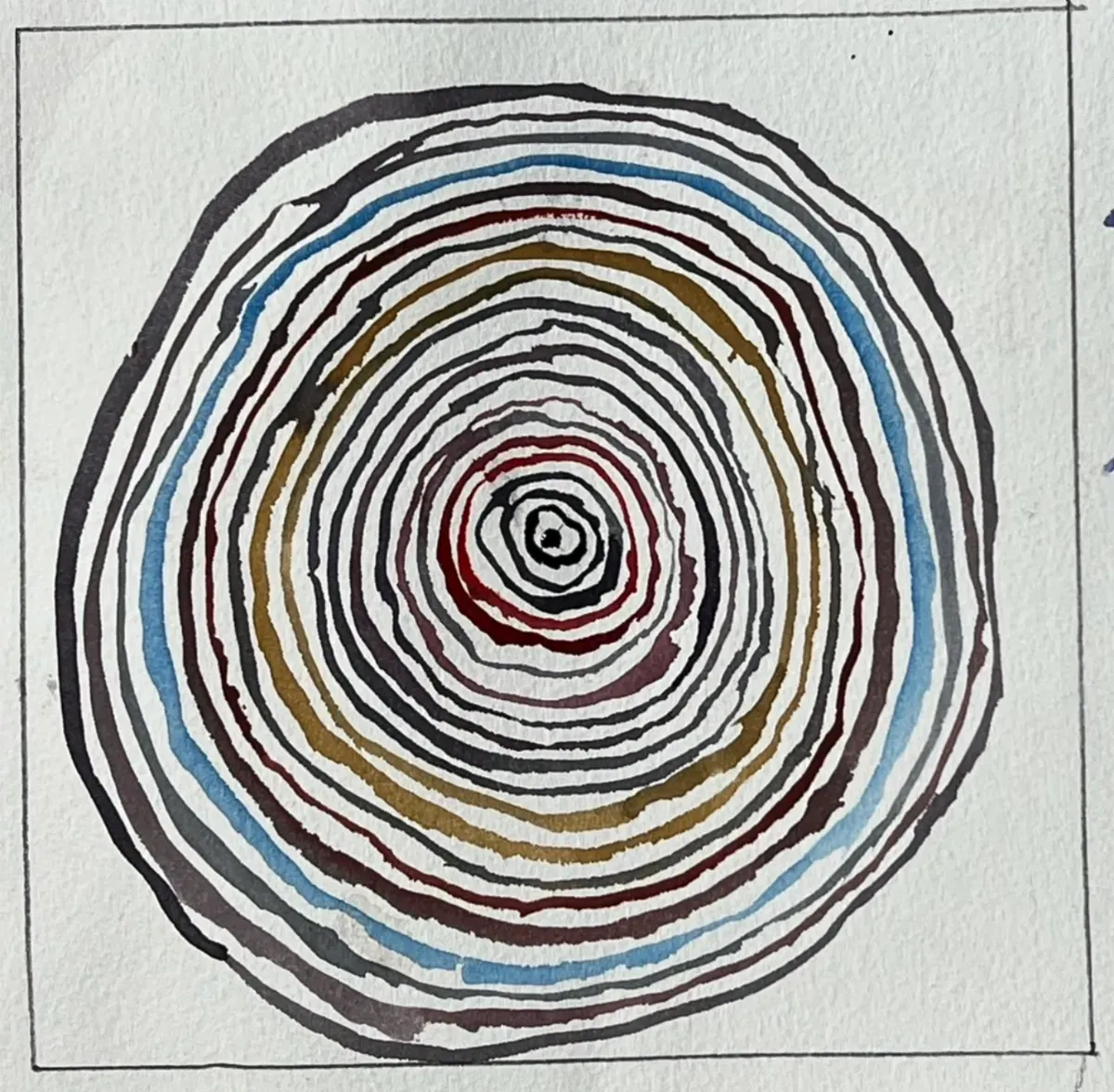Watercolor concentric circles painted with a dagger brush in black, blue, red, and gold on cold press paper.
