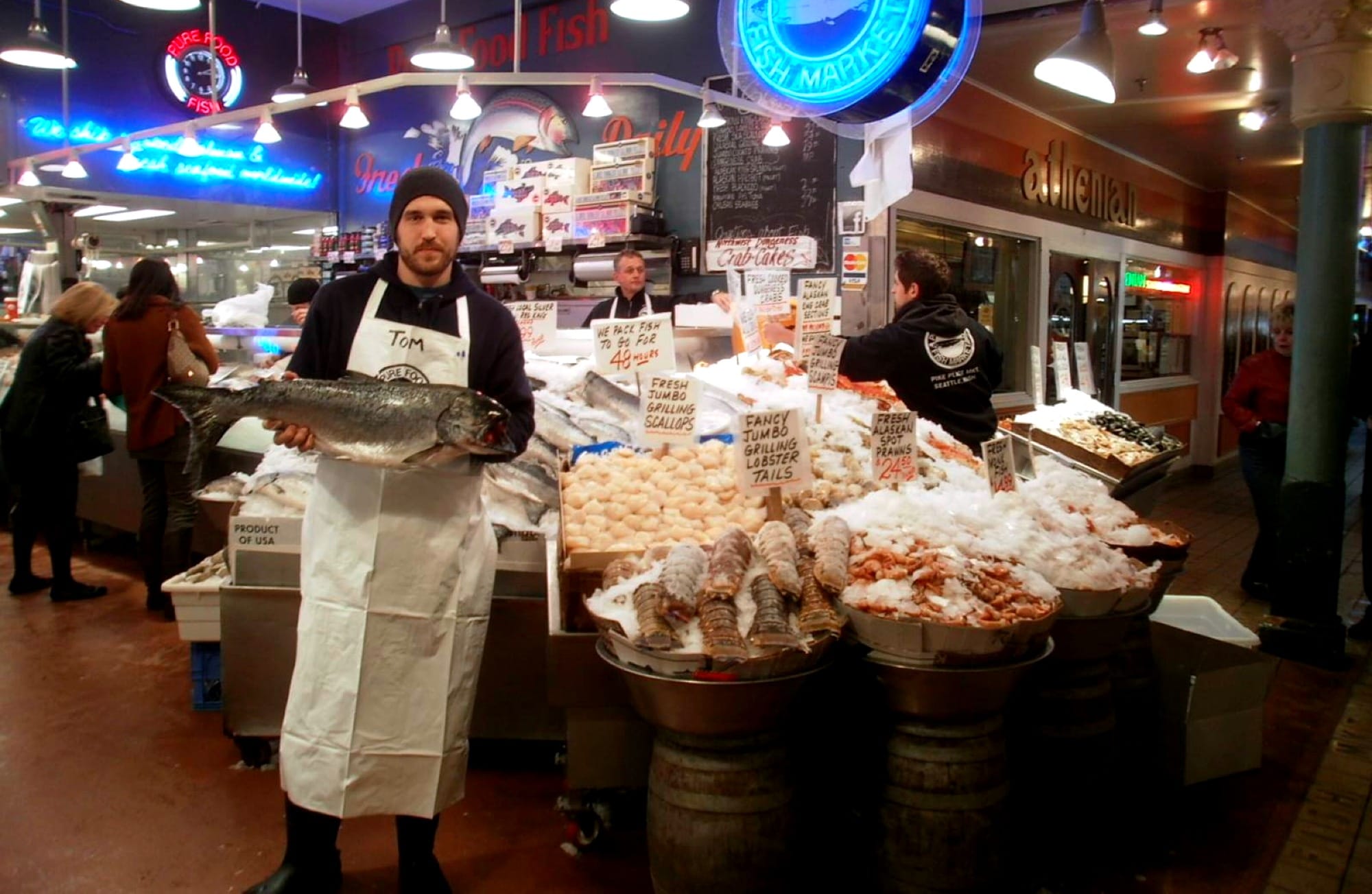 Fishmonger at a seafood market ready to serve customers