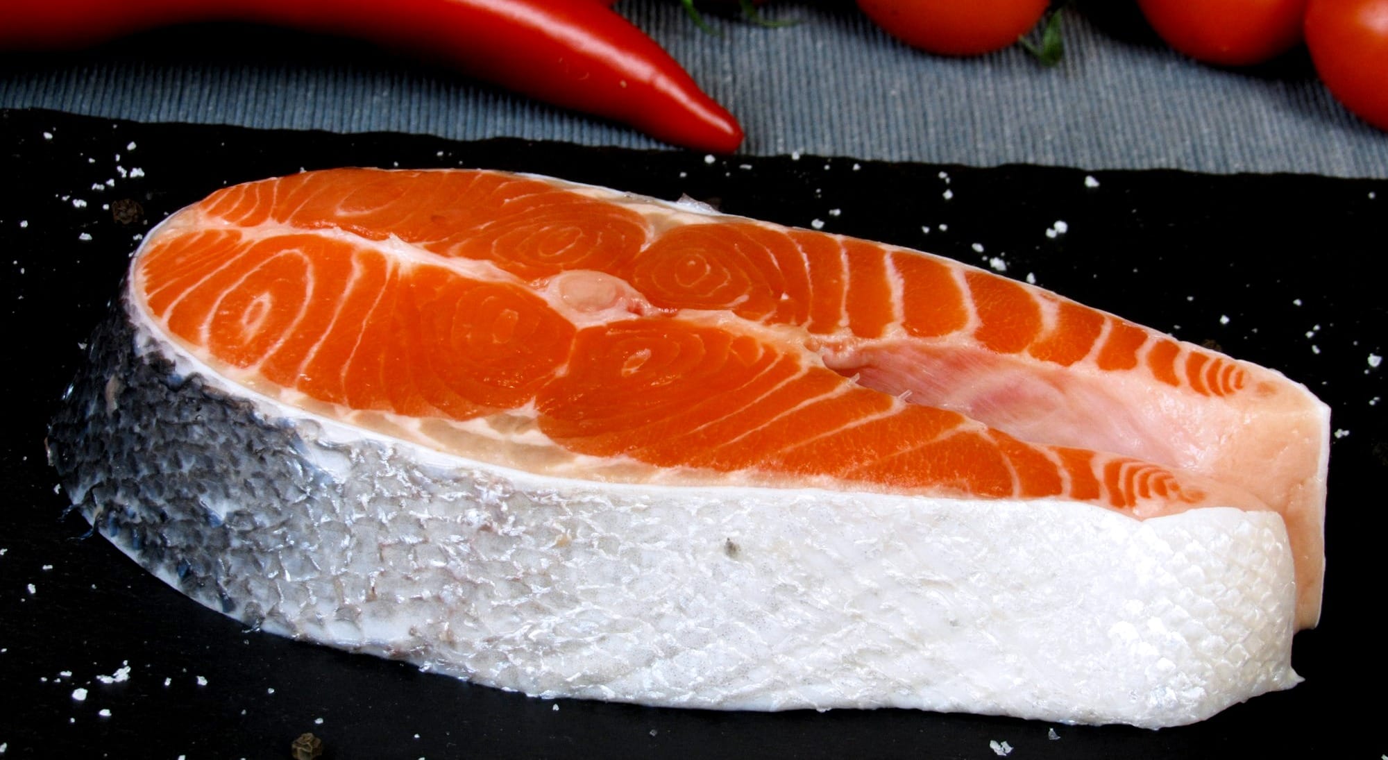 a salmon steak on top of a cutting board