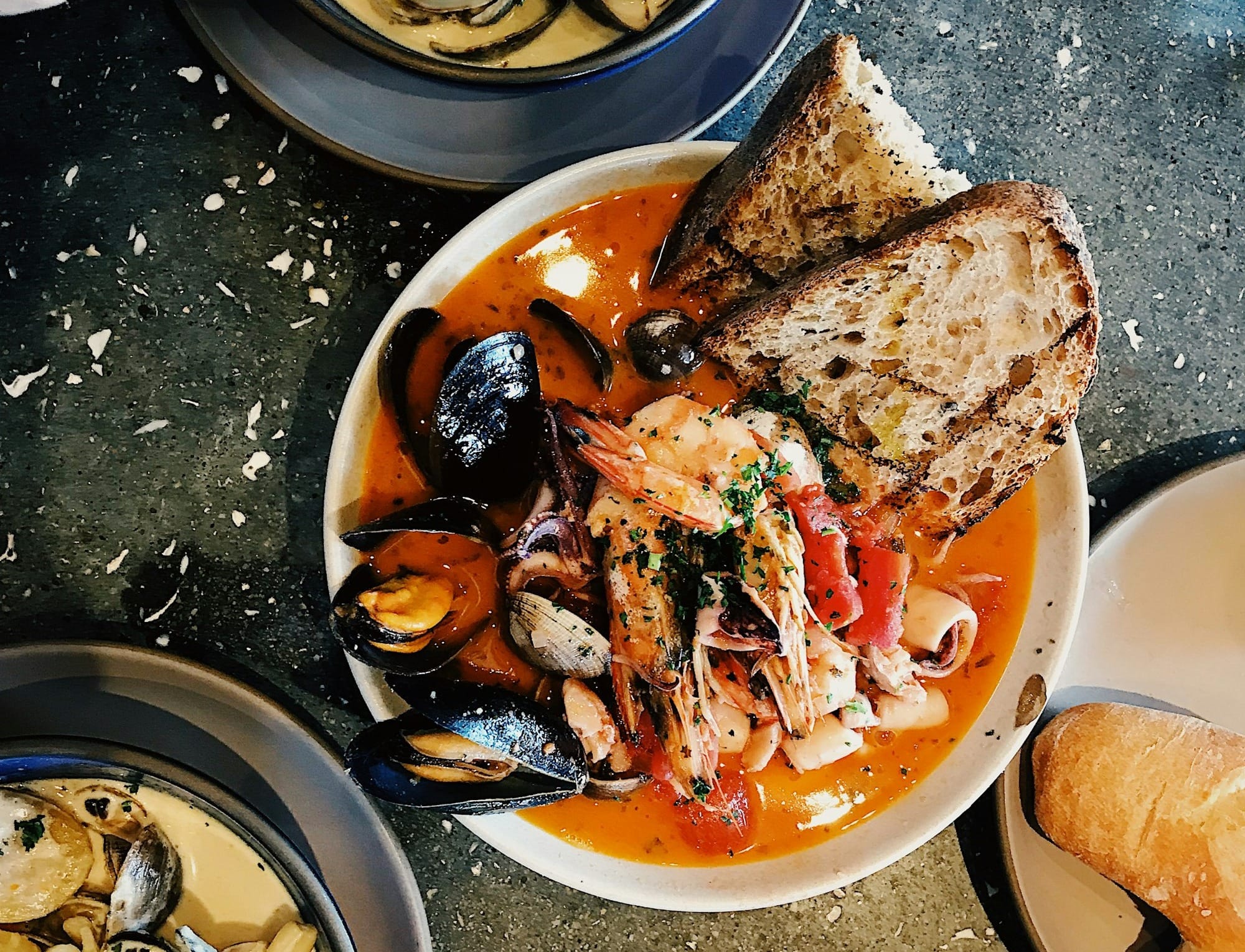 round white ceramic bowl with seafood Cioppino in it