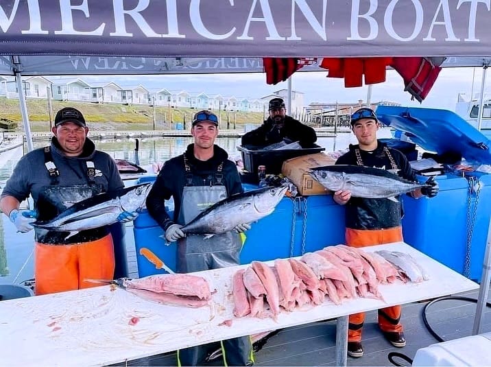 Fishermen selling fresh caught fish from a dock