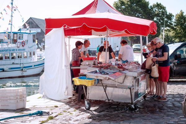 Seafood stand with customers buying fresh seafood