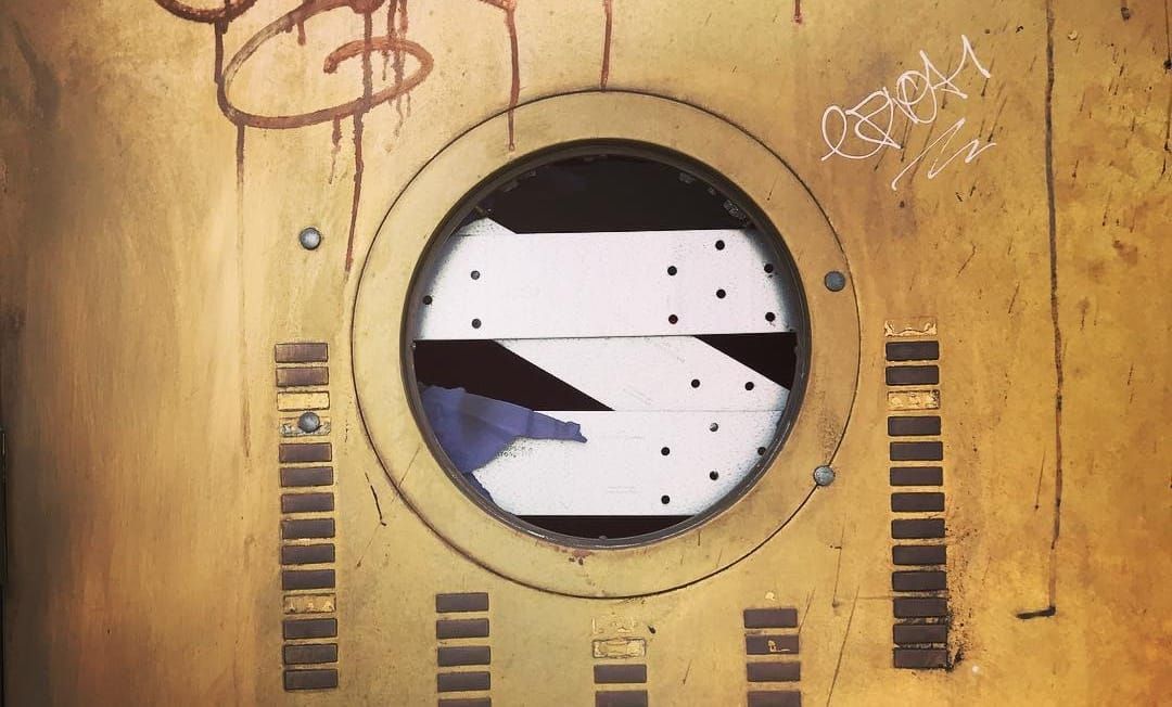 Snapshot of a beautiful, worn brass-colored door in San Francisco
