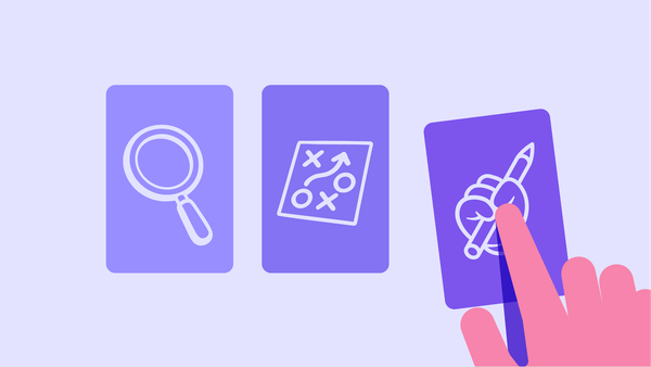 돋보기, OX, 연필을 쥔 손이 그려져 있는 세 개의 카드가 있고 세번째 카드를 사람의 손이 가리키고 있다.