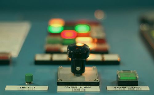 A control panel with illuminated indicators and a backup control switch.