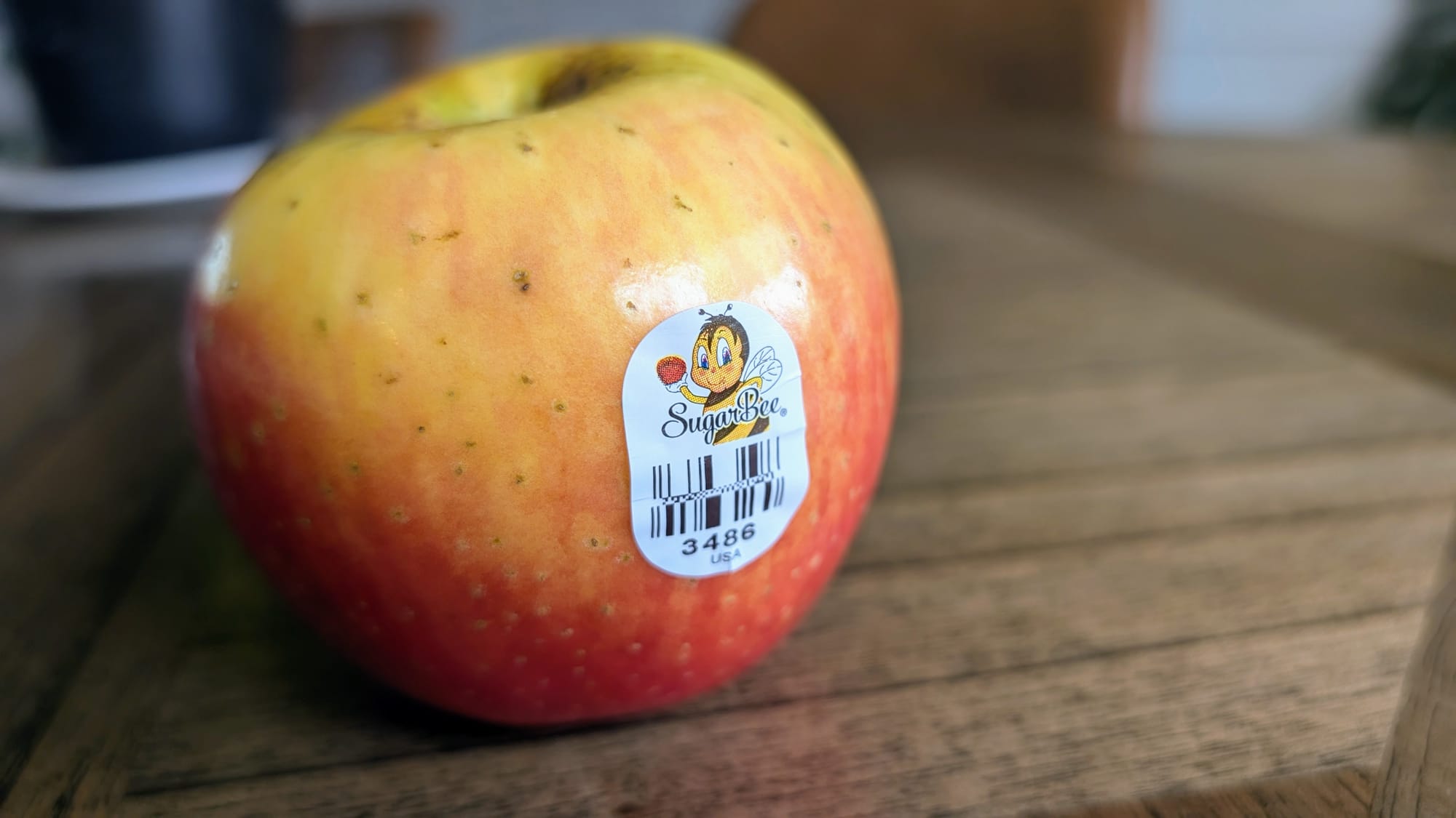 Sticker of a honey bee on the SugarBee Apple.