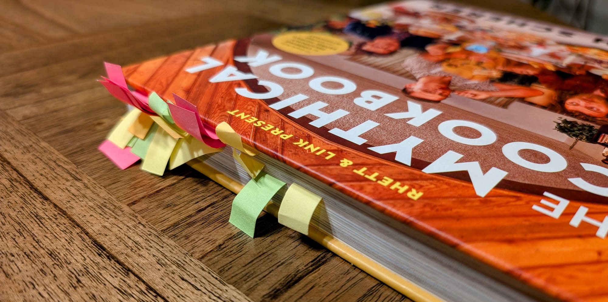 A cookbook with post it flags sticking out of the pages.
