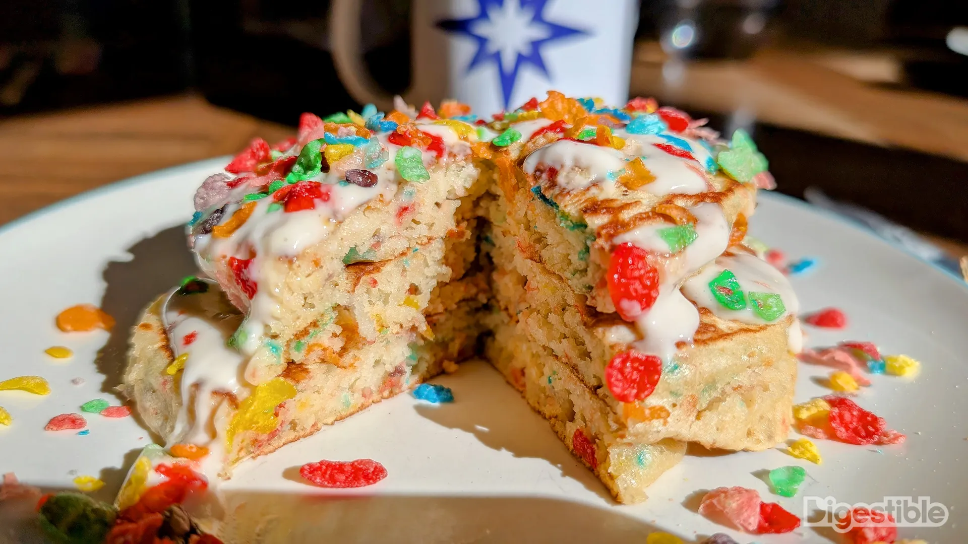 A triple stack of pancakes with a slice cut out.