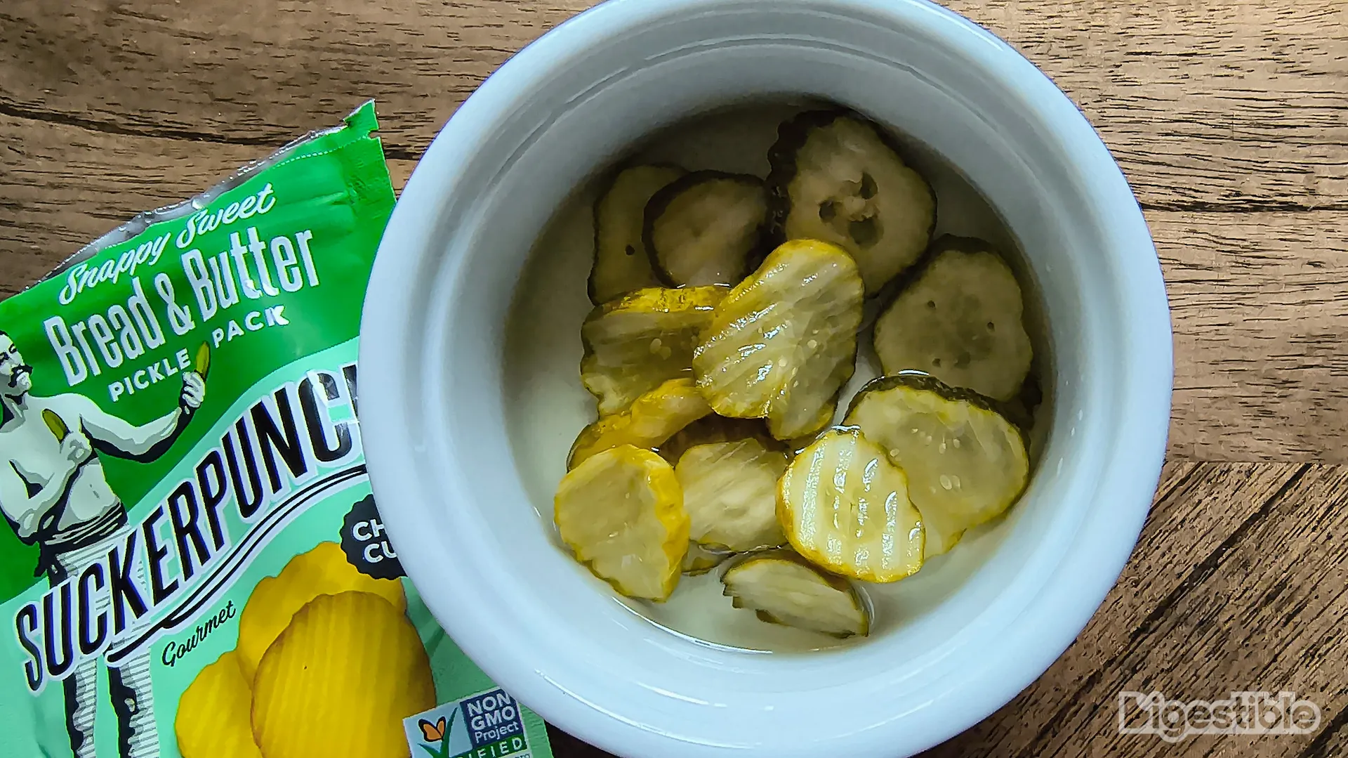 Bowl of pickles next to pickle pouch bag.