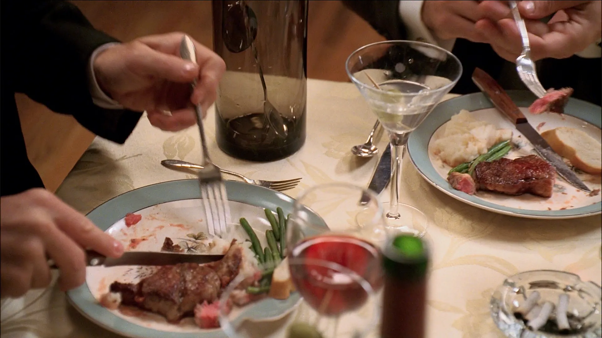 Plates of steak, mashed potatoes, and green beans.