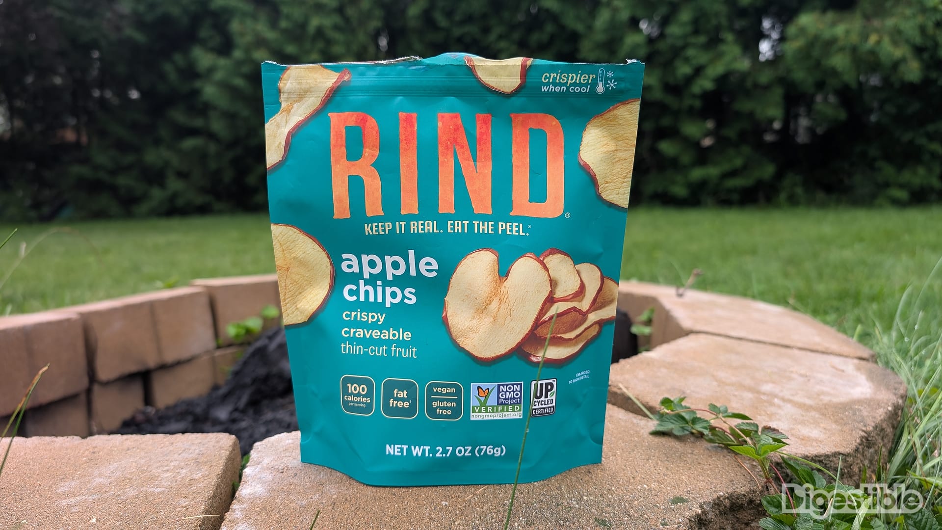 A bag of Apple Chips RIND Snacks on a fire pit.