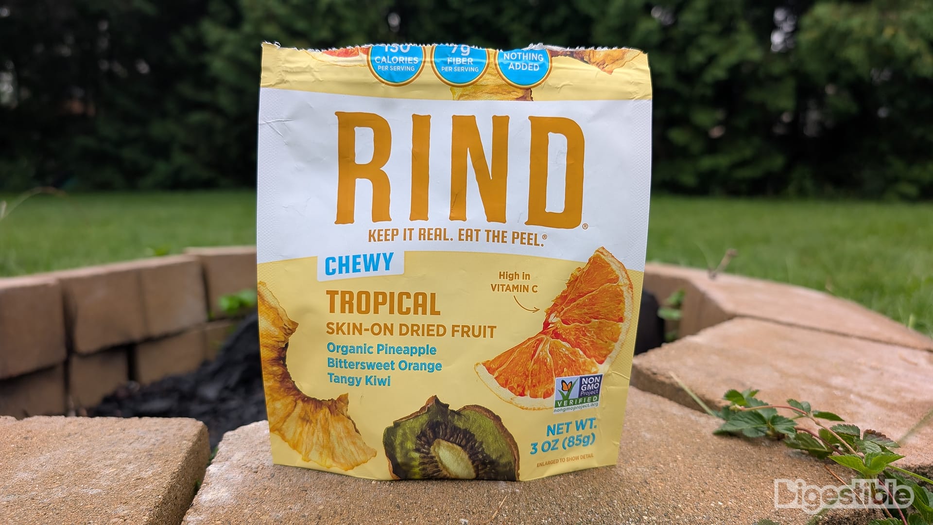 A bag of Tropical RIND Snacks on a fire pit.