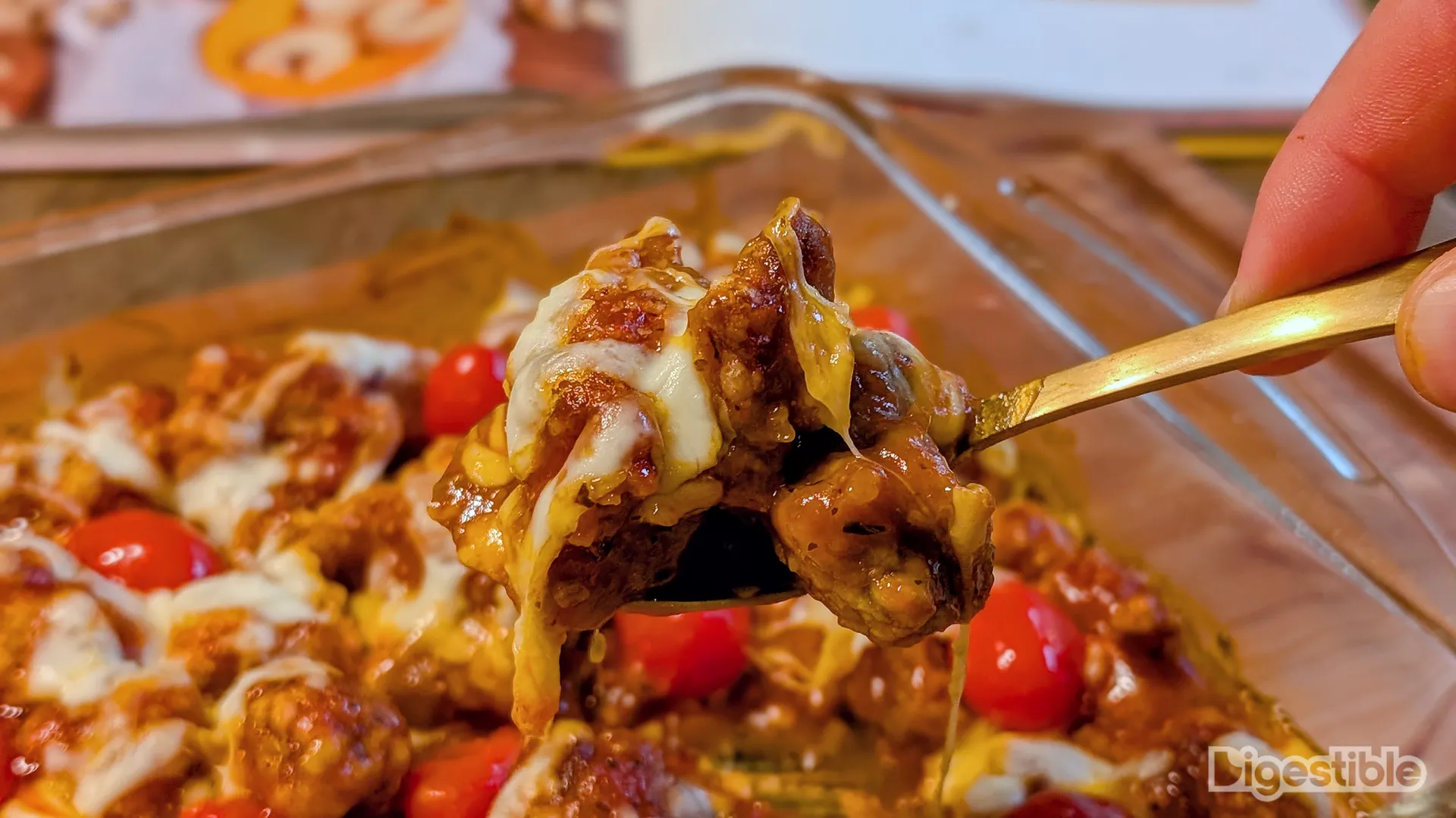Orange chicken parm on a spoon.